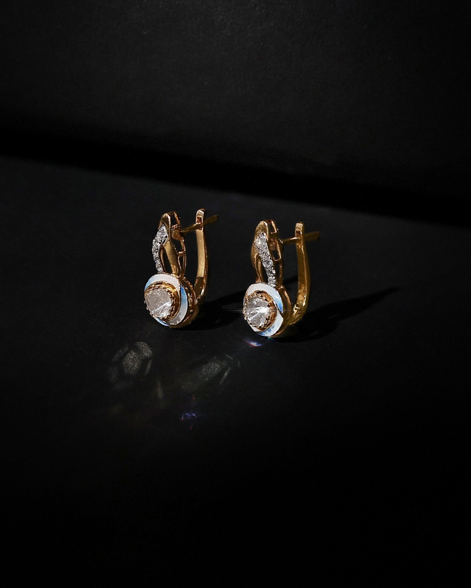 Seren Arc Earrings in 14K gold with a diamond and polished-gold curved design