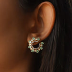 14k gold stud earrings with green gemstones, Polki, and diamonds.