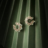 14k gold stud earrings with green gemstones, Polki, and diamonds.