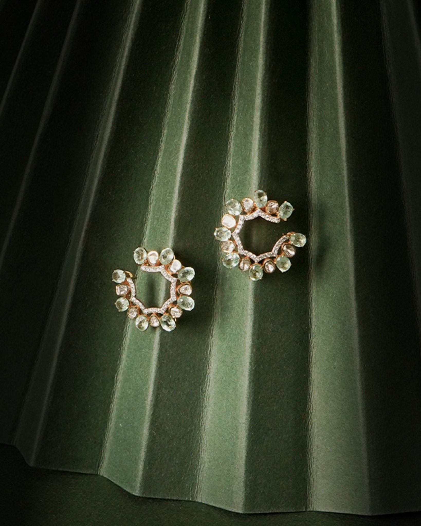 14k gold stud earrings with green gemstones, Polki, and diamonds.