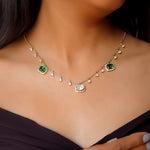 Model wearing Scintillate Emerald necklace with vivid green glamour