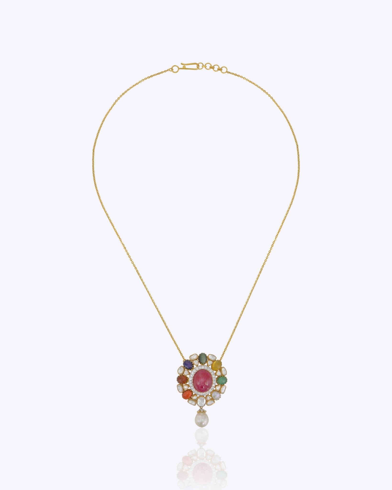 Roshanara Bloom pendant in gold with a ruby cabochon framed by uncut diamond petals