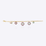 18K gold charm bracelet with floral motifs, talaf stones, and Polki accents.