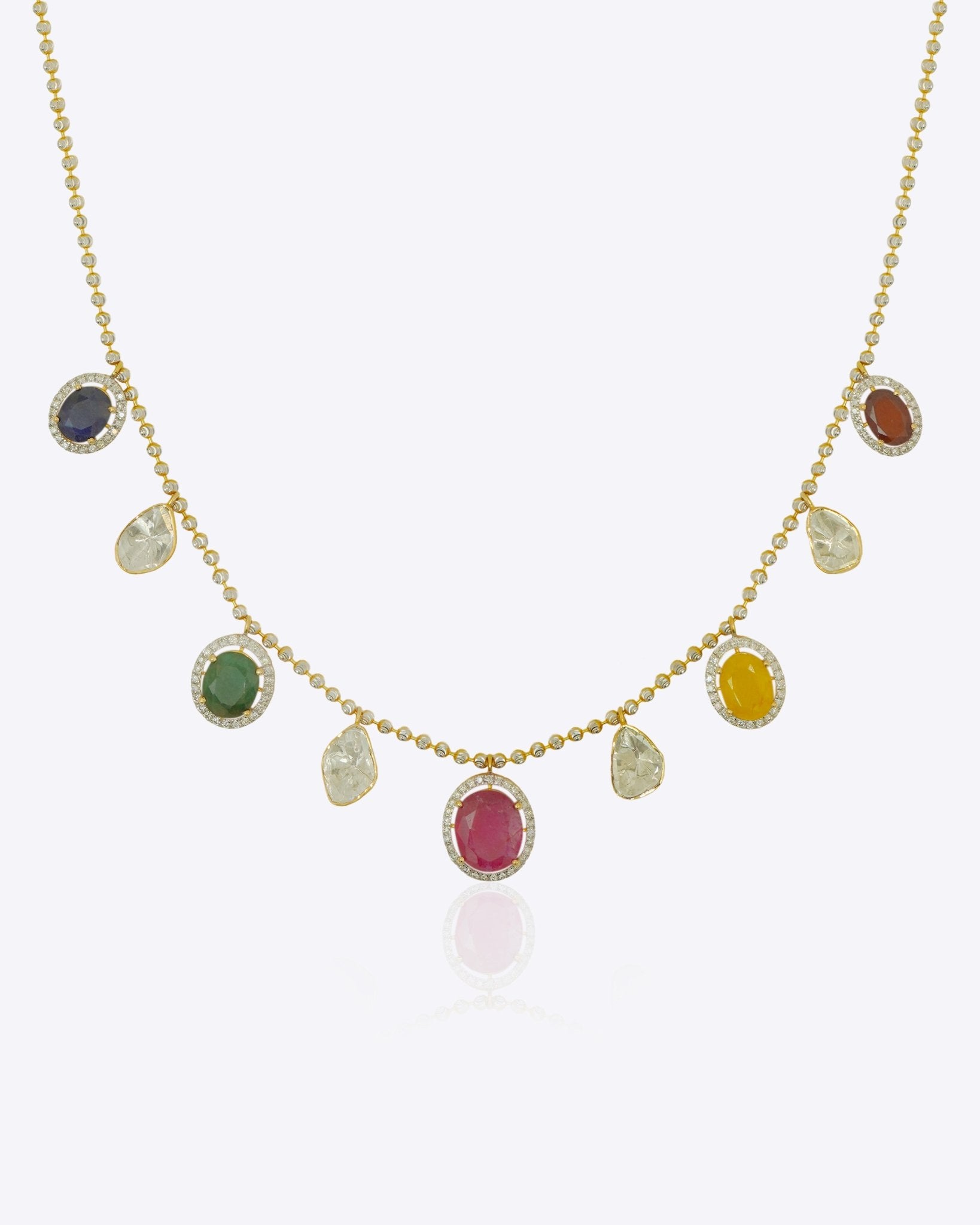 18K gold necklace with a graceful rhythmic design and a soft rosy tone.