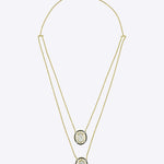 Layered 14K gold necklace with dual oval Polki diamond pendants and diamond accents.
