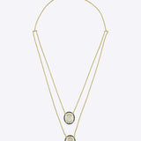 Layered 14K gold necklace with dual oval Polki diamond pendants and diamond accents.