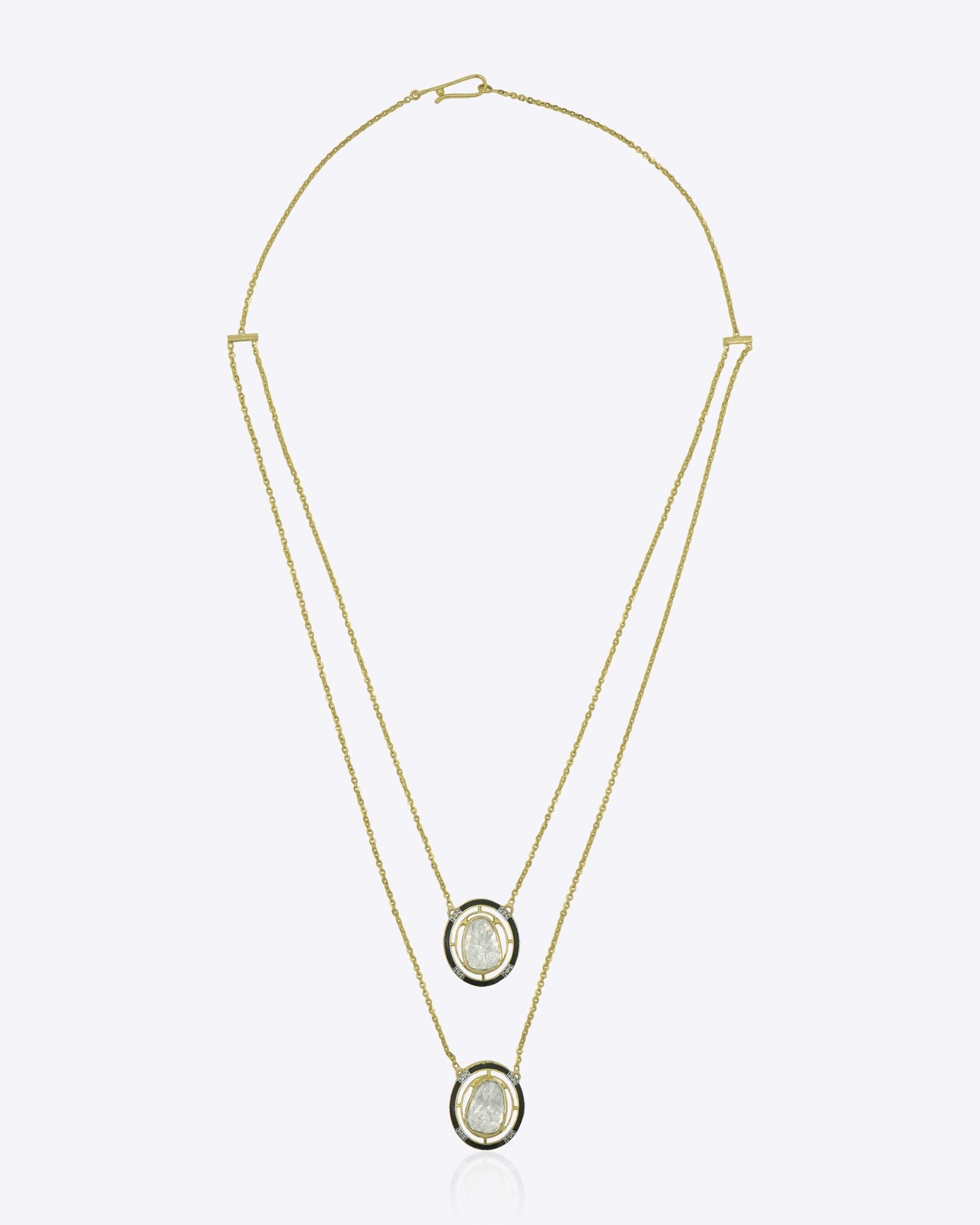Layered 14K gold necklace with dual oval Polki diamond pendants and diamond accents.