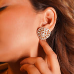 Heart-shaped perennial earrings in diamond polki design shown gracefully adorning ear.