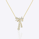 14kt gold necklace with delicate bow design and cascading drops