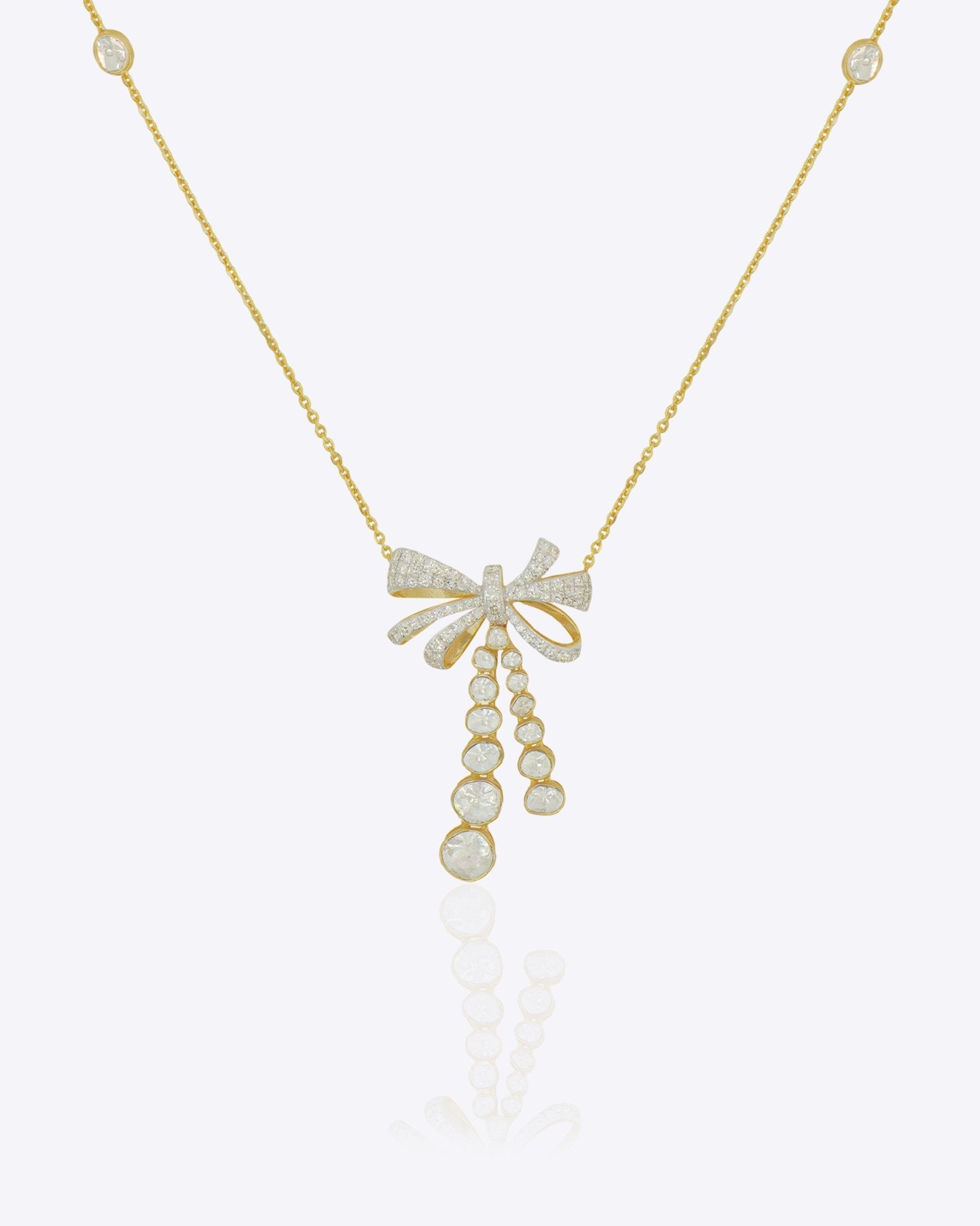 14kt gold necklace with delicate bow design and cascading drops