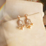 Jewelry image of pearl and polki fusion in wave-inspired frame.
