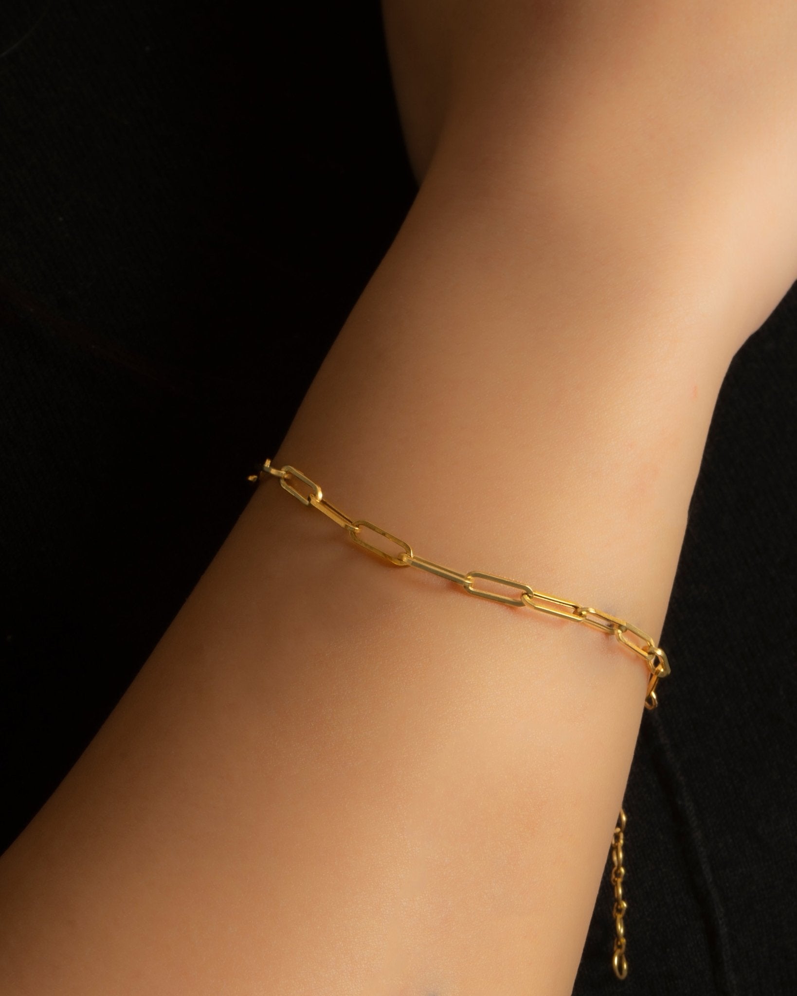 18K solid gold paper clip chain bracelet, shown worn solo for an everyday minimal look.