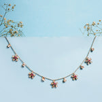 Floral Whisper Necklace in 14K gold with ruby-centred florals and Polki drops.