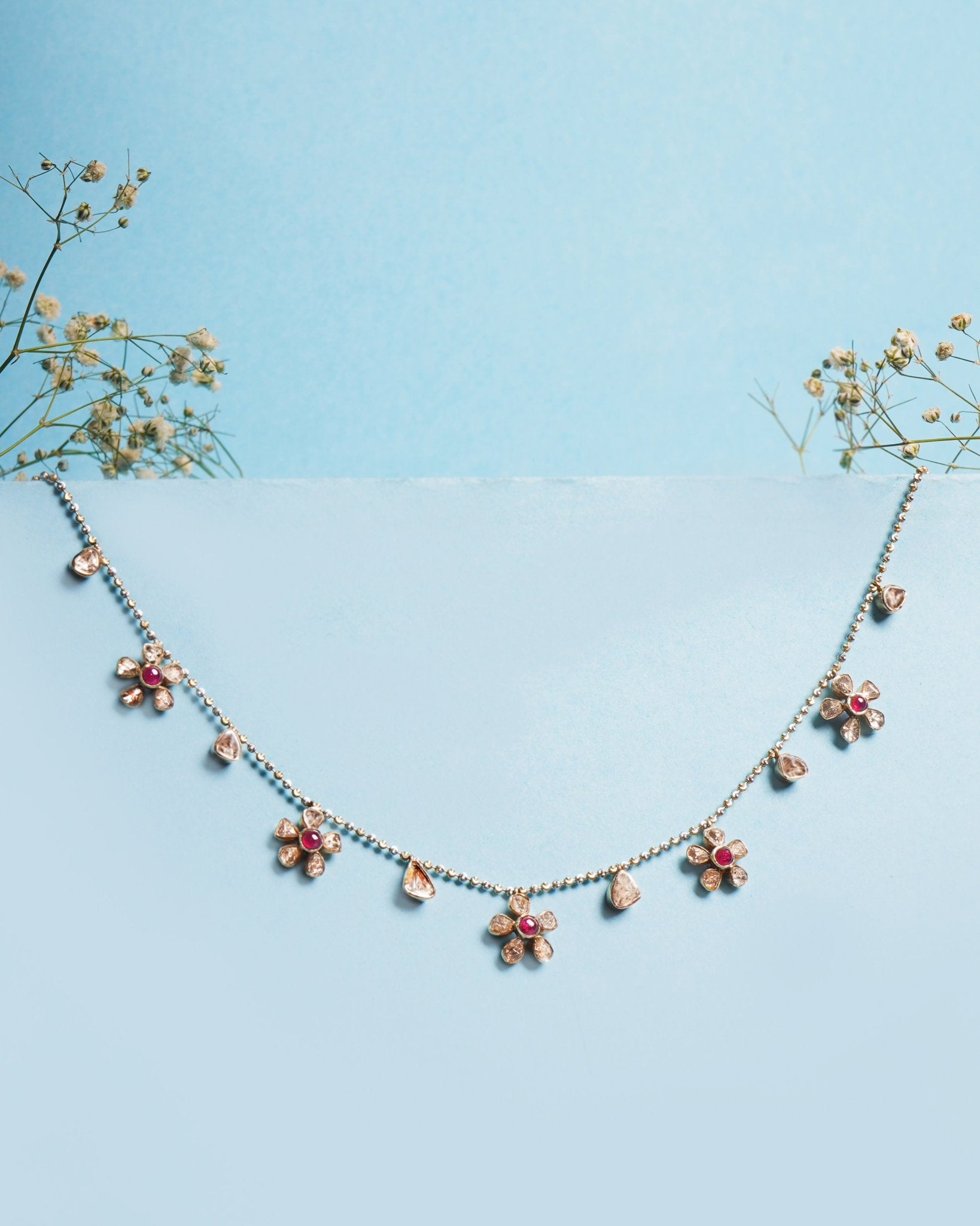 Floral Whisper Necklace in 14K gold with ruby-centred florals and Polki drops.