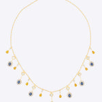 Sapphire and Polki gemstone cascade necklace in 14K gold with warm-toned stones.