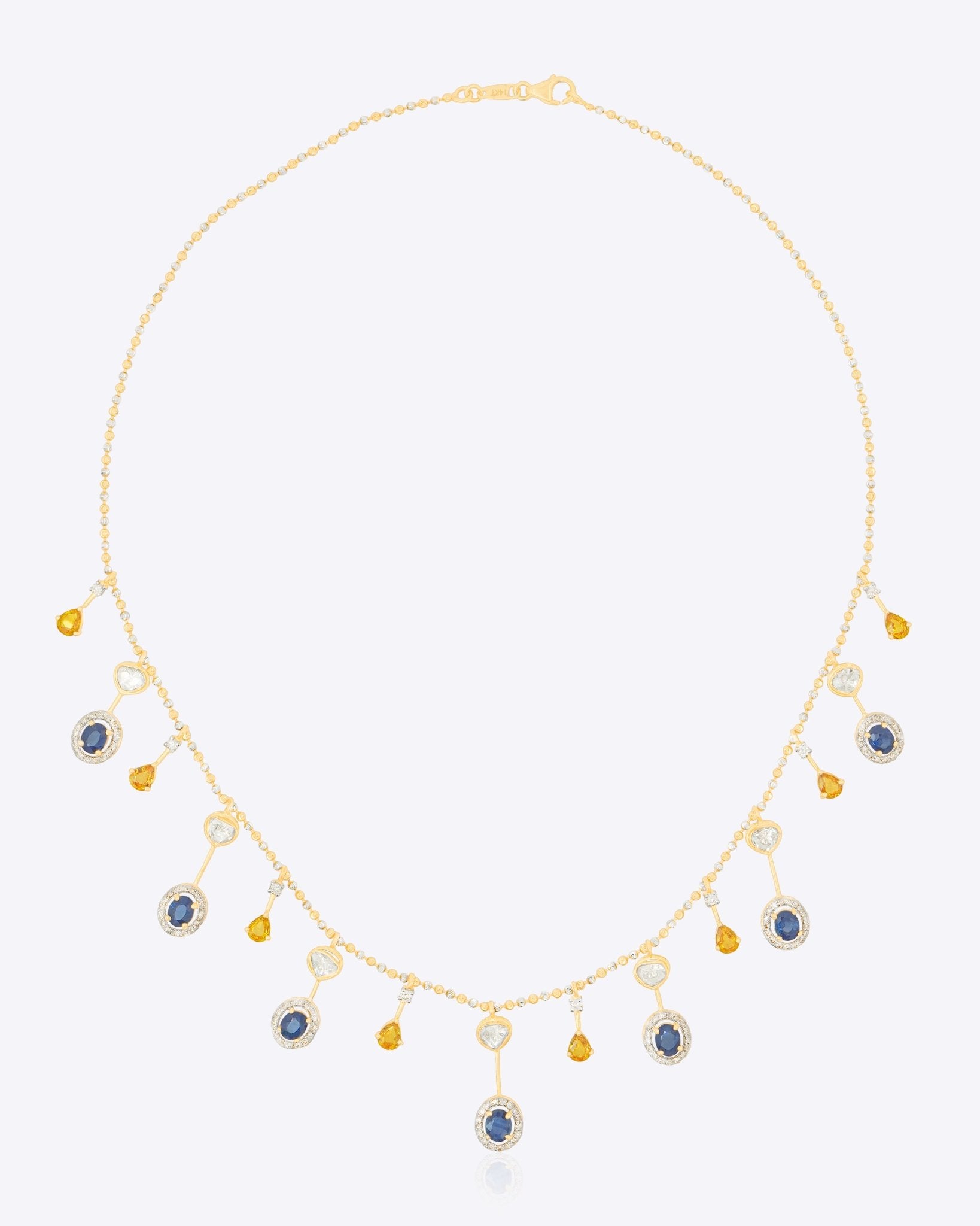 Sapphire and Polki gemstone cascade necklace in 14K gold with warm-toned stones.