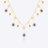 Sapphire and Polki gemstone cascade necklace in 14K gold with warm-toned stones.