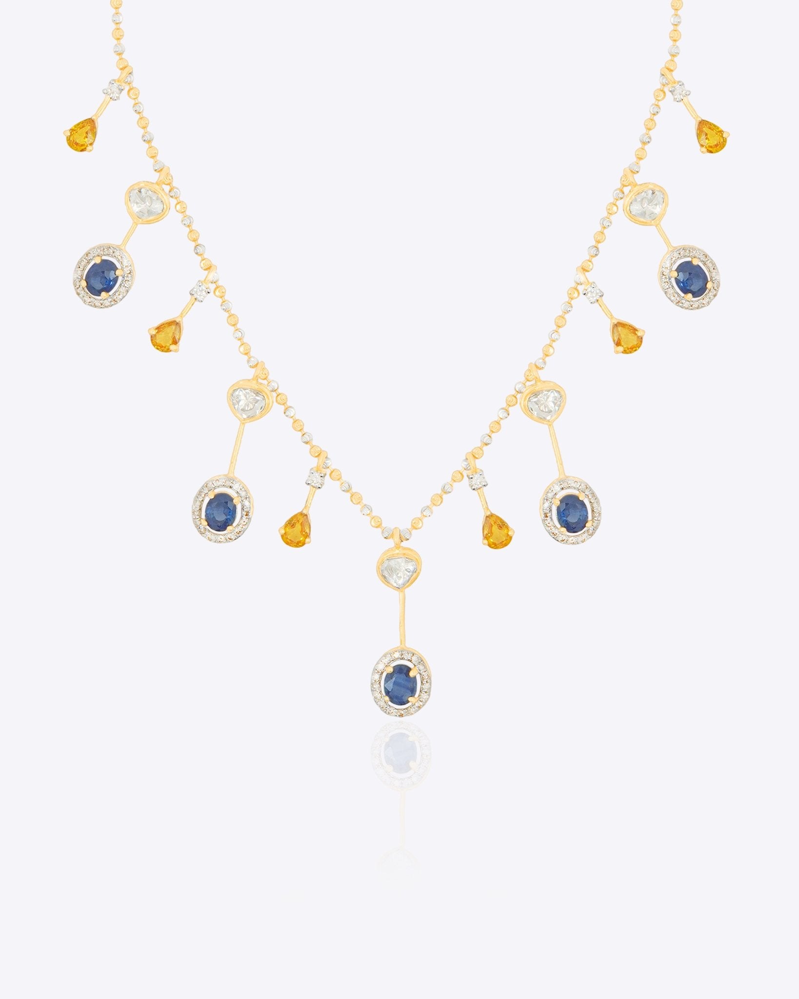 Sapphire and Polki gemstone cascade necklace in 14K gold with warm-toned stones.